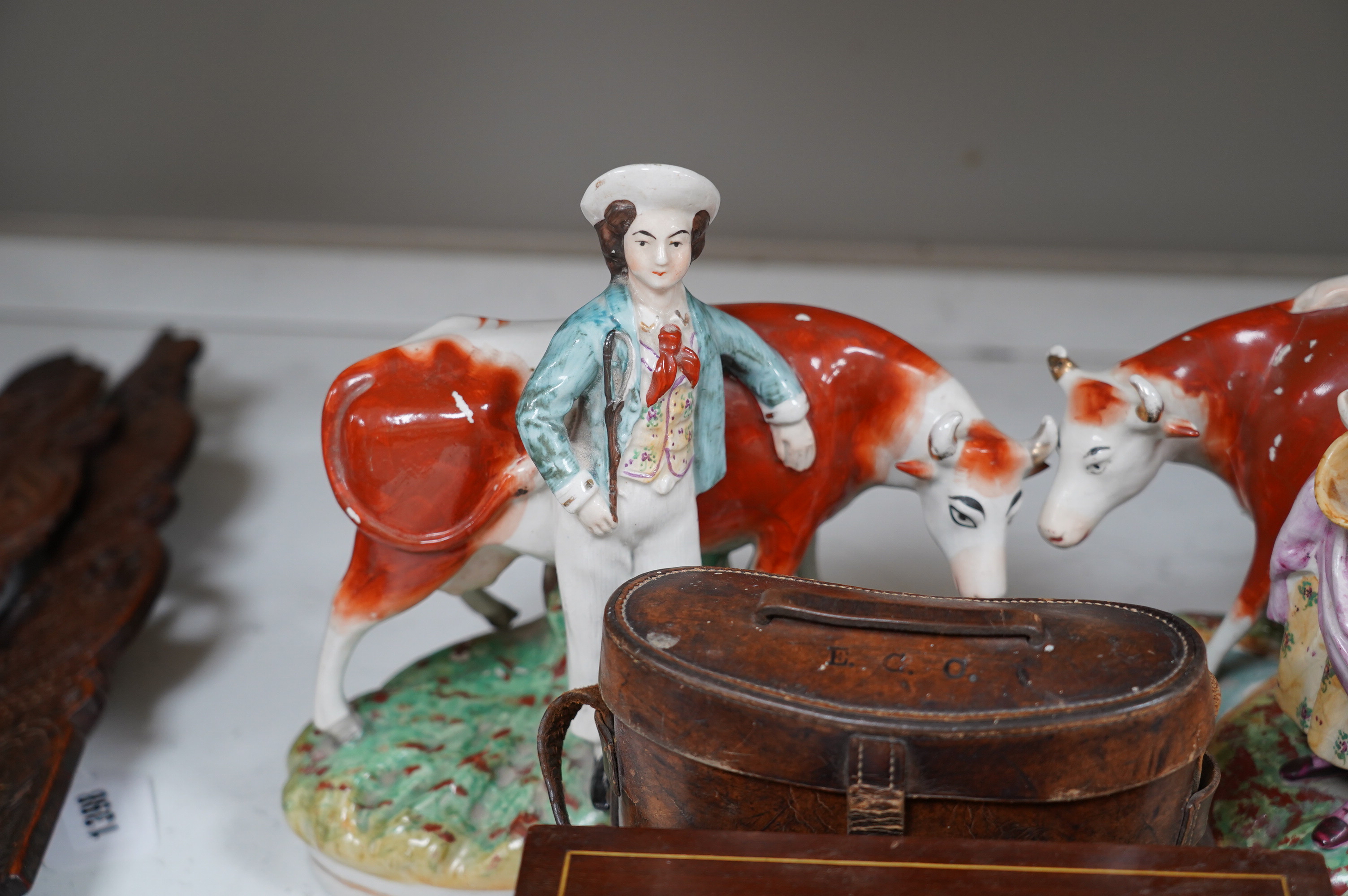 A pair of Staffordshire cow groups, two boxes and a cased pair of binoculars. Condition - fair